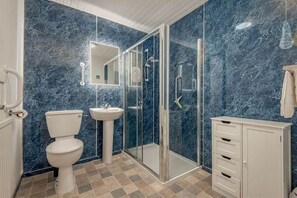 A bathroom with a toilet, sink, and shower. - The Cross Keys Apartment (85D Market Street) (St Andrews)