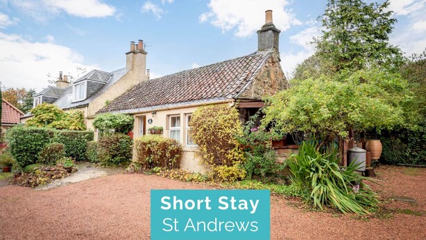 A traditional house with a tiled roof, a front garden, and a pathway leading to the entrance. - Park Mill Cottages | Mill Cottage (St Andrews)