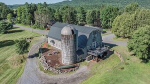 A large barn with a silo, surrounded by a well-maintained lawn and a road. - Perfect location for family vacation or family gathering (Hyde Park)