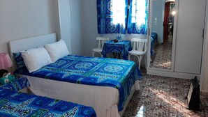 A bedroom with two beds, a desk, and a wardrobe. - Gohar Guest House (Giza)
