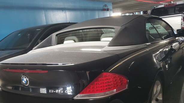 A black BMW 645i parked in a dimly lit parking garage. - Calm Relaxation Haven in SOUTH BEACH MIAMI that is also 420 Friendly. (Miami)