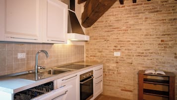 Condo | Private kitchen | Fridge, stovetop, cookware/dishes/utensils, cleaning supplies