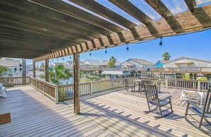 Relax on the deck with comfortable seating and dining areas, surrounded by a safe railing and scenic views.