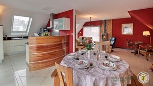 A modern apartment with a dining area, kitchen, and living space. - Les Bancs Roux - Binic Etables SUR MER (BINIC ETABLES SUR MER)