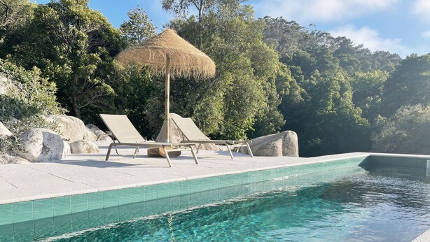 A clear swimming pool with lounge chairs and a thatched umbrella. - Eighteen21 Houses - Casa da Mula in Quinta Velha (Sintra)