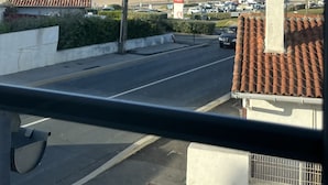 A coastal road with a clear view of the beach and houses in the background. - RESIDENCE DE LA PLAGE (Bidart)