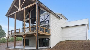 A modern two-story house with a wooden deck and large windows. - Lakeview Getaway | 6BR Near Table Rock (Cape Fair)