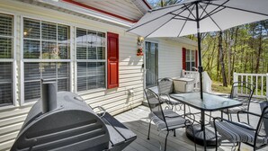 A covered outdoor patio with a grill, dining table, and chairs. - Walk to Lake Chatuge! Hayesville Cabin w/ Fire Pit (Hayesville)
