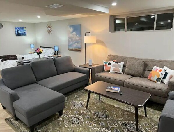 Relax in this stylish living room with a gray sofa, brown sofa, and patterned rug.