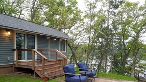 A deck with outdoor furniture and a fire pit.