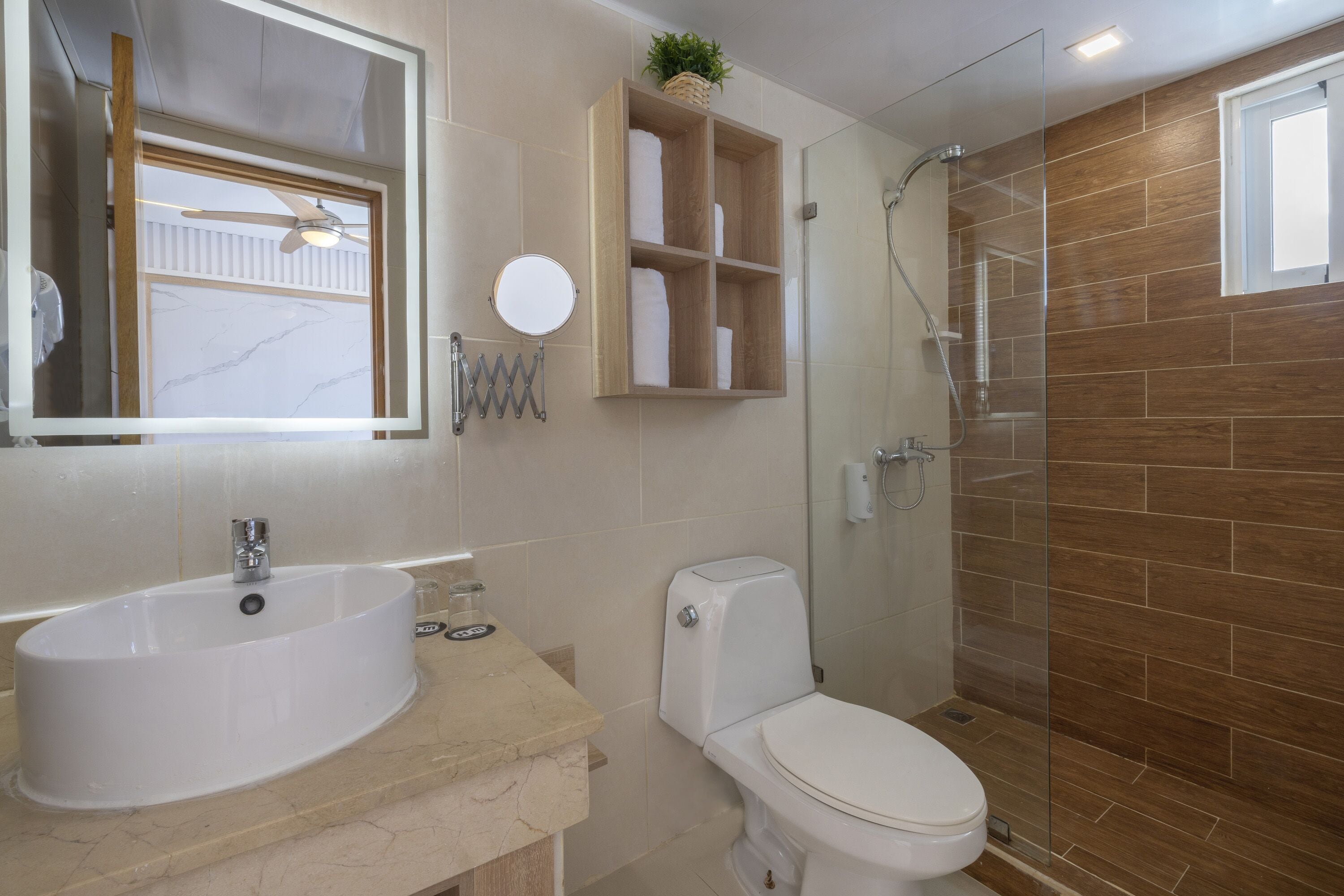 A bathroom with a sink, toilet, and shower.