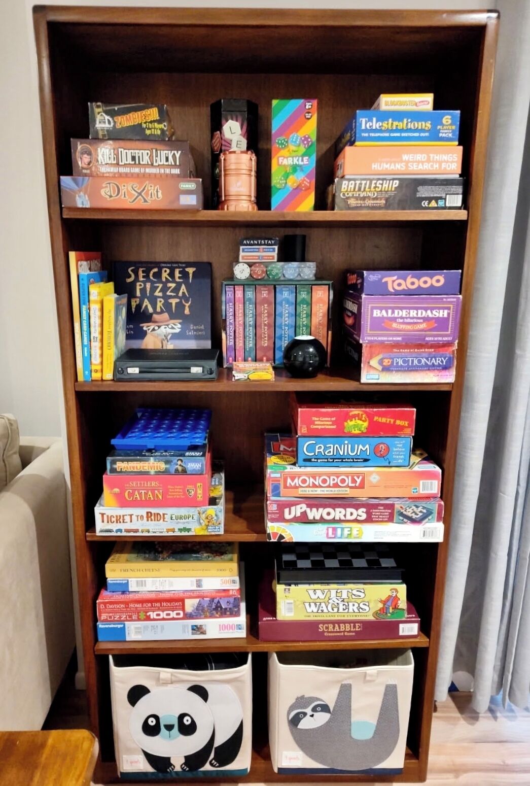 A bookshelf with various board games and books.