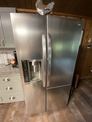 A stainless steel refrigerator with a water dispenser and a digital display. - Shore Thing Waterfront Home with private covered boat dock on Toledo Bend Cove (Hemphill)