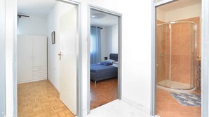 Ein Schlafzimmer mit Bett, Dusche und Kleiderschrank.
