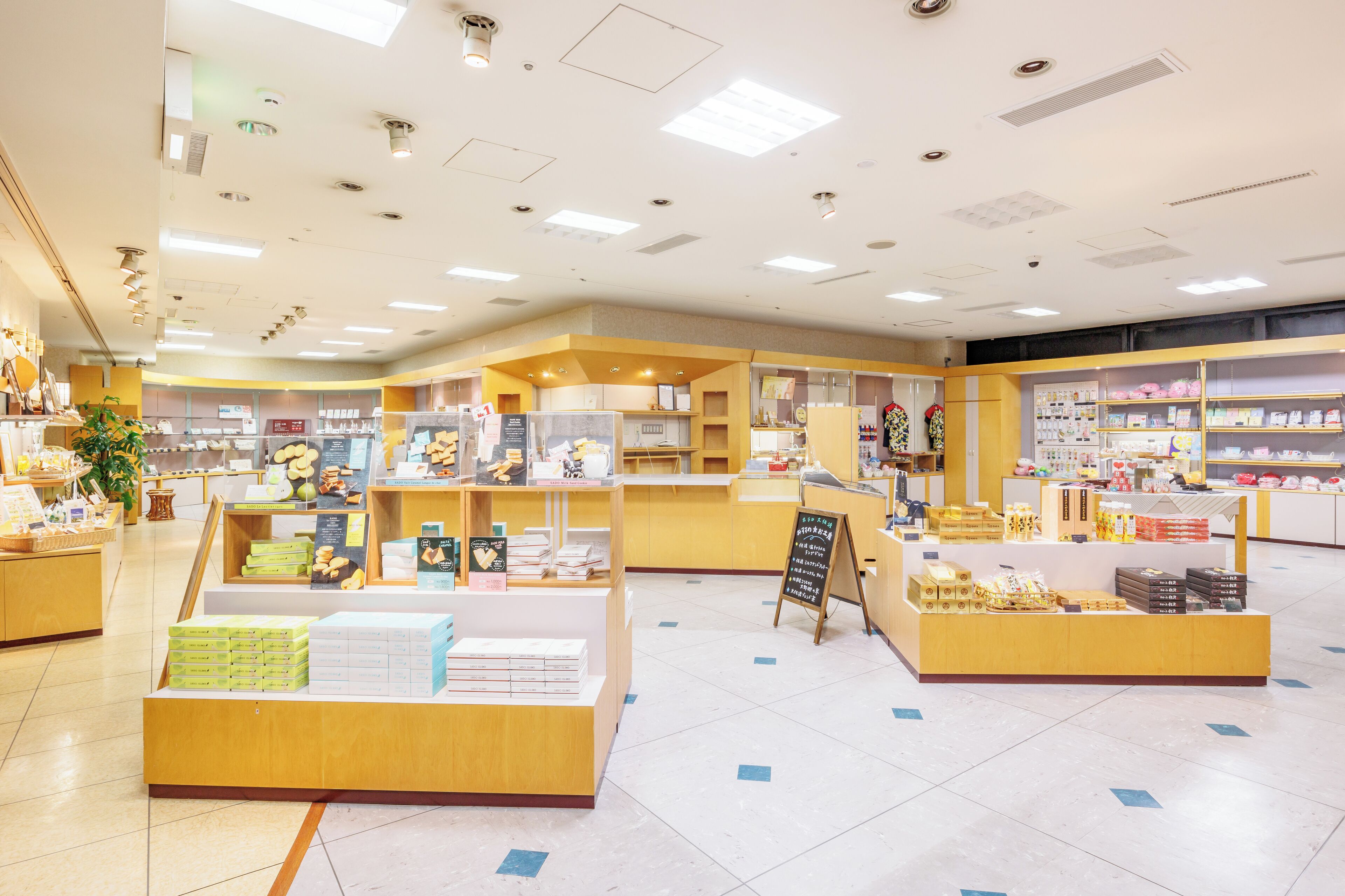 A brightly lit store with various products on display, including boxes and baskets.