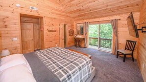 A wooden cabin room with a bed, a desk, and a chair. - Top-of-Wisp*6bed/6ba*Hottub* (McHenry)