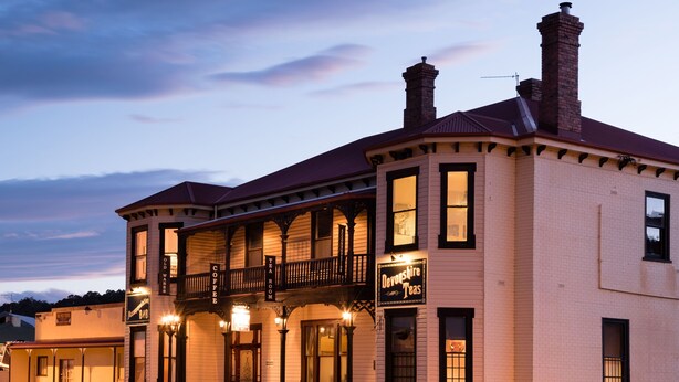 A two-story building with a balcony and a sign that reads "Devonshire Teas." - The Exchange Beaconsfield - Offering Heritage Accommodation (Beaconsfield)