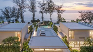 A modern resort with multiple buildings, a rooftop pool, and a view of the sea at sunset. - Veyla Natai Residence - Luxury Pool Villa  (Takua Thung)