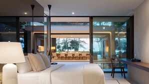 A modern bedroom with a large bed, bedside tables, a desk, and a dining area with chairs. - Veyla Natai Residence - Luxury Pool Villa  (Takua Thung)