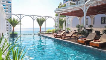 Outdoor pool, open 6:30 AM to 10:00 PM, pool umbrellas