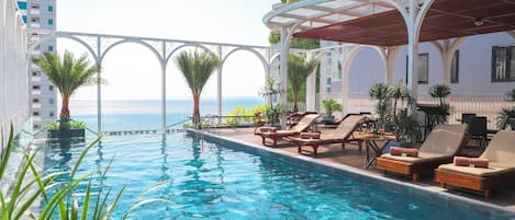 Outdoor pool, open 6:30 AM to 10:00 PM, pool umbrellas