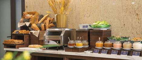 A buffet counter with various food items and beverages.