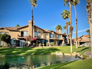 A large, multi-story house with a swimming pool, surrounded by palm trees and a well-maintained lawn. - The View! Palm Desert Country Club Villa (Palm Desert)