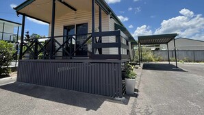 A two-story building with a covered porch and a fenced area. - Kilcoy Motel (Kilcoy)