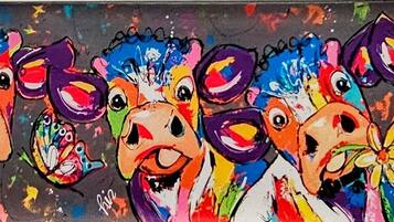A colorful abstract painting with multiple faces and vibrant splashes of paint.