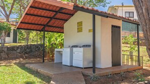 A small laundry facility with two washing machines, a covered area, and a door. - Amazing Condo! Playas del Coco (Provincia de Guanacaste)