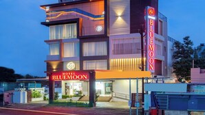 A multi-story hotel with a prominent 'Blue Moon' sign, featuring a modern architectural design with balconies and large windows. - HOTEL BLUEMOON (Palayankottai)