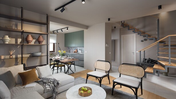 A modern living room with a sofa, chairs, a coffee table, and a staircase leading to a kitchen. - Modern apartment with hot tub (Poreč)