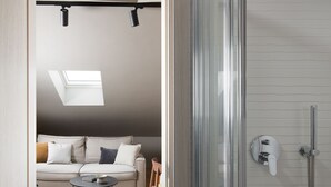 A modern bathroom with a glass shower enclosure, a towel rack, and a toilet. - Modern apartment with hot tub (Poreč)