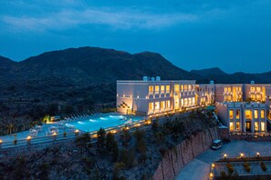 Relax by the pool with lounge chairs and umbrellas, surrounded by breathtaking views of the landscape.