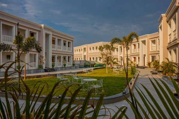 Guests can relax in the serene courtyard, surrounded by beautifully maintained gardens and stylish seating areas.