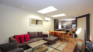 A modern apartment with a living area, dining space, and kitchen.