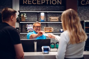 A reception area with a counter, a digital kiosk, and a sign that reads "RECEPTION". - Break Sokos Hotel Koli Kylä (Lieksa)
