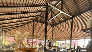 An indoor space with a high ceiling and a wooden structure. There are tables and chairs arranged for dining or meetings. - Rainforest Huahin Village Hotel (Hua Hin)