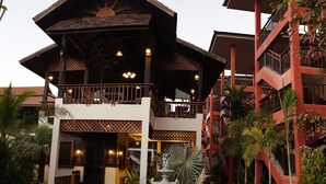 A two-story building with a balcony and a covered entrance. - Rainforest Huahin Village Hotel (Hua Hin)