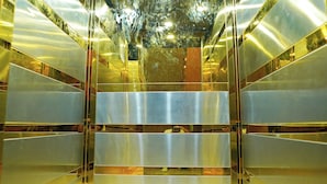 A modern elevator interior with metallic walls and a patterned floor. - Maharaja Palace Near Medanta Gurgaon  (Gurugram)