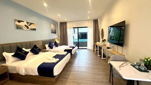 A hotel room with two beds, a desk, a TV, and a balcony with curtains. - Fresh Resort Pattaya (Pattaya)