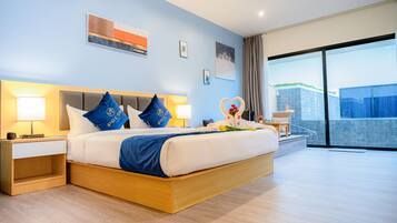 A modern hotel room with a large bed, two bedside tables, a nightstand, and a view of the city through large windows.