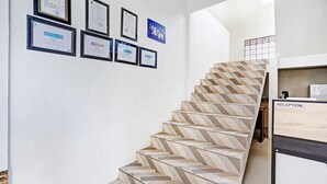 Una escala amb mosaics geomètrics que condueix a una zona de recepció.