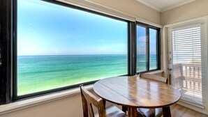 A room with a large window offering a view of the ocean. - Oceanfront, Hot Tub, Private Beach, Fire Pit (Oceanside)