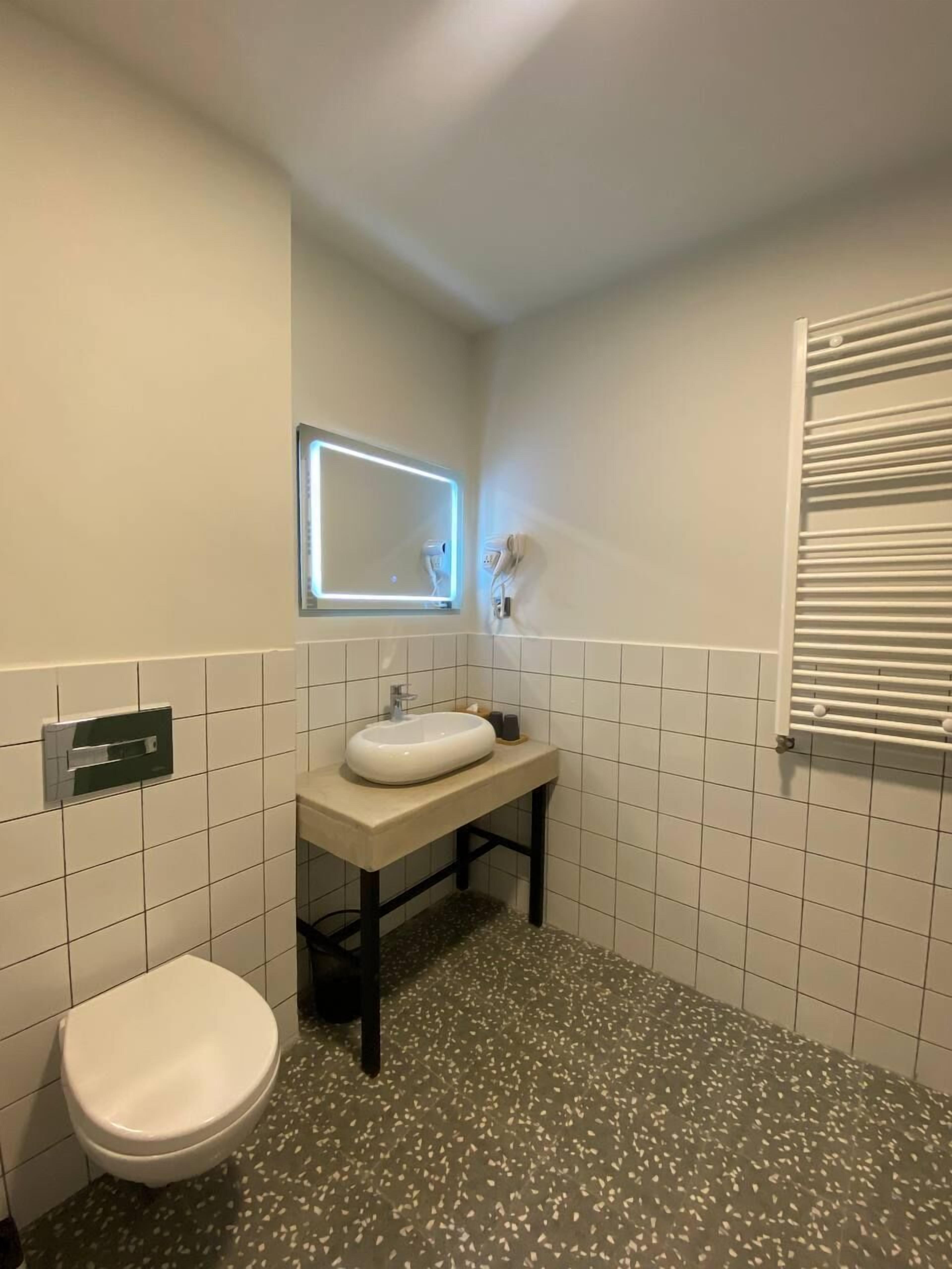 Family Quadruple Room | Bathroom | Rainfall showerhead, designer toiletries, hair dryer, towels