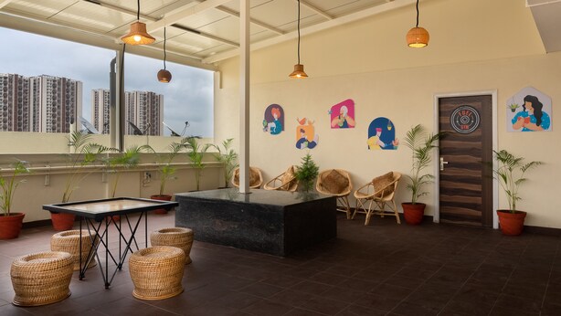 A spacious indoor area with a pool table, seating, and potted plants. - COVIE Bannerghatta 141 (Bengaluru)