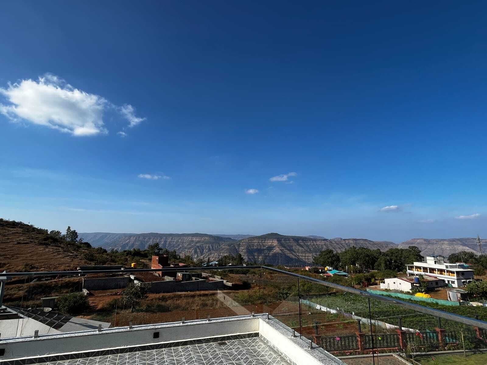 A residential area with a clear view of distant mountains under a blue sky.