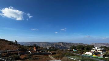 A residential area with a clear view of distant mountains under a blue sky.