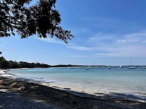 Enjoy a serene beach experience with a gentle slope into the calm waters.