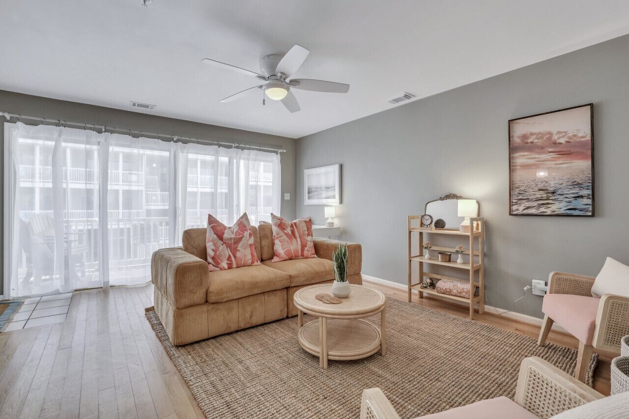 A living room with a sofa, round coffee table, and a bookshelf.